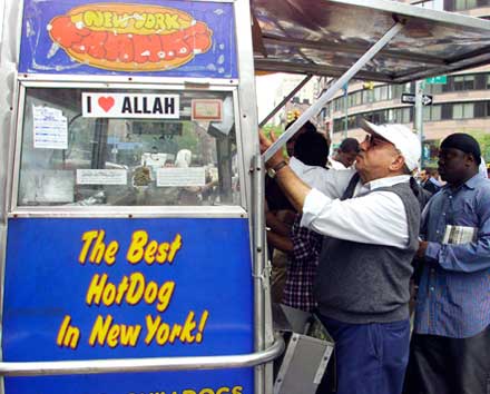 Muslim worshipers stoping by a hot dog stand