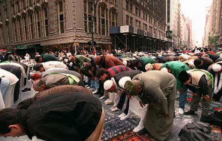 Muslim men bow for afternoon prayer on New York's Madison Avenue