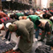 men bowing for a prayer on a New York's street before starting the United American Muslim Day Parade in Sept. 1997