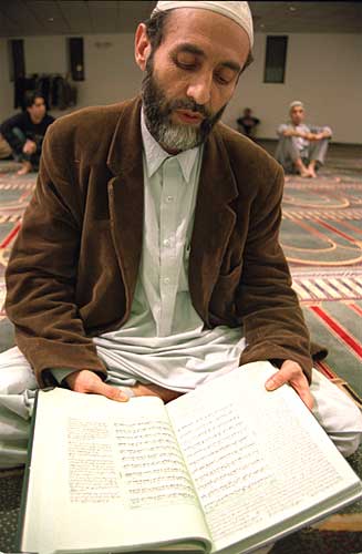 A devout Muslim reads from the Koran