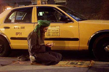 taxi driver praying in the middle of his shift